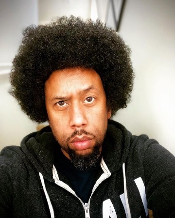 Picture of Affion Crockett in a black hoodie with his long hair